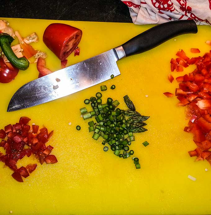 cutting board with vegetables for hash brown egg muffins