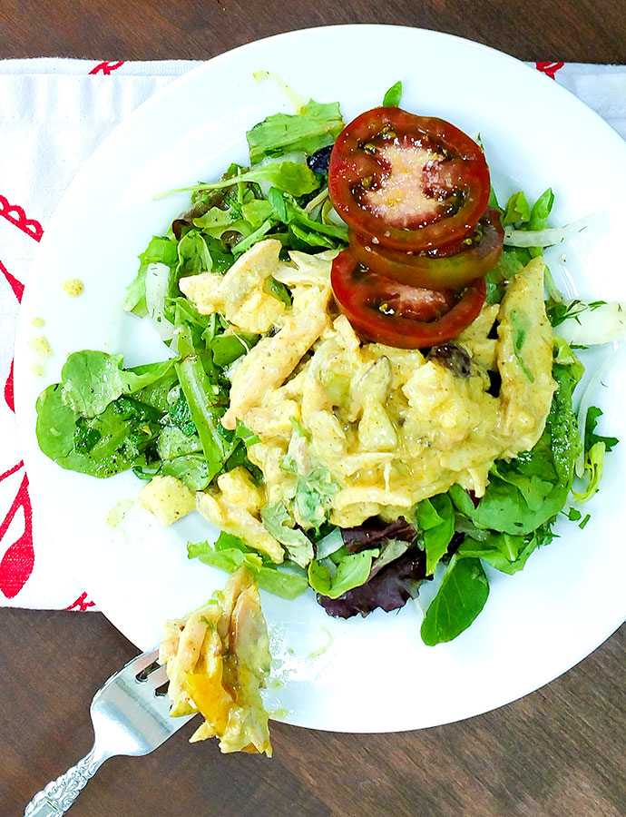 Chicken salad with curry and hot mango chutney on bed of greens