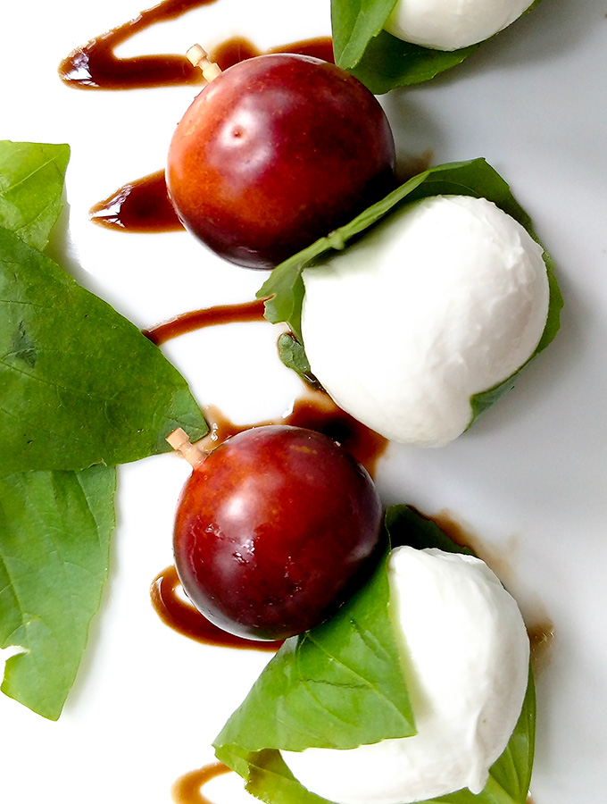 Caprese salad on a stick with heirloom tomatoes and balsamic glaze