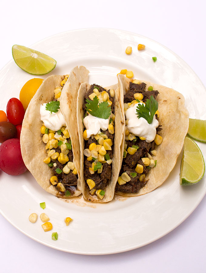 Better than Chipotle beef barbacoa recipe in tacos with corn salsa