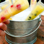 Pail full of mango berry popsicles, a fresh flavorful treat for a hot day
