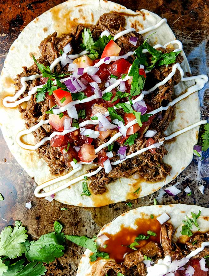 beef barbacoa tacos served open face
