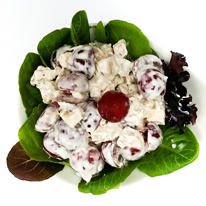 Chicken salad with grapes served over greens
