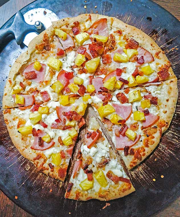 Homemade Hawaiian Pizza on baking stone