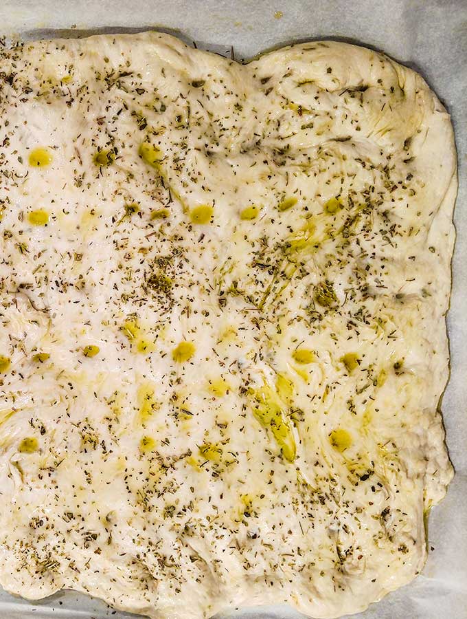 Bread machine focaccia with dimples and herbs and olive oil
