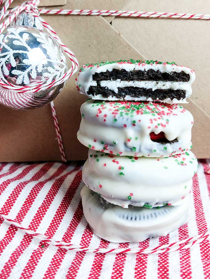 stack of chocolate dipped Oreo Christmas cookies with sprinkles