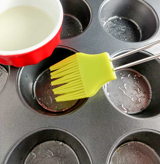Brushing muffin tin with oil