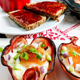 Baked eggs in ham cups on platter