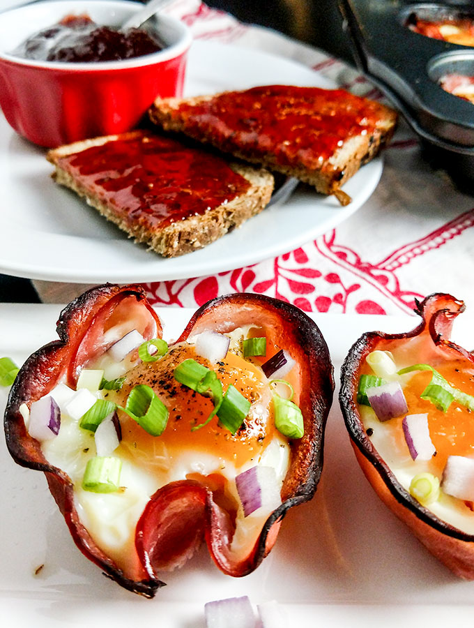 Baked eggs in ham cups on platter