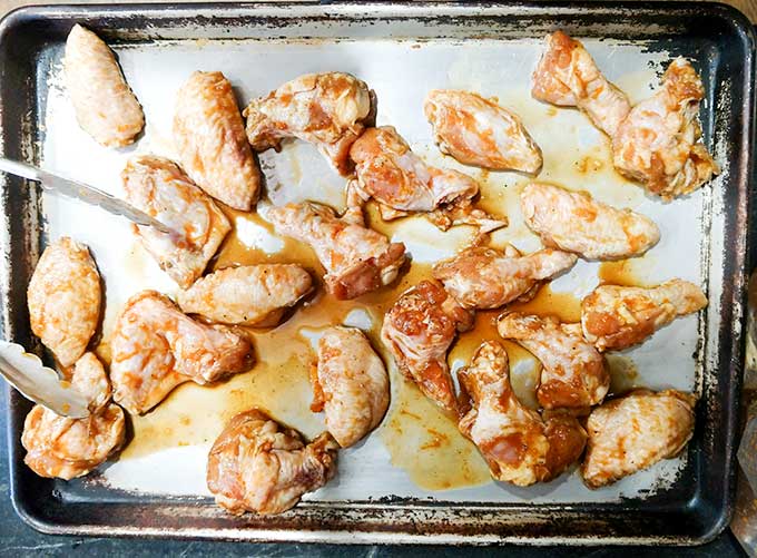 Raw Asian chicken wings on baking tray