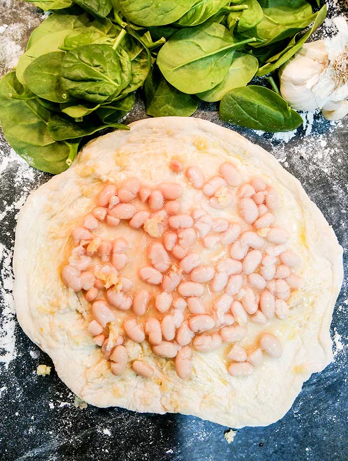 white beans on tortilla for spinach and white bean pizza