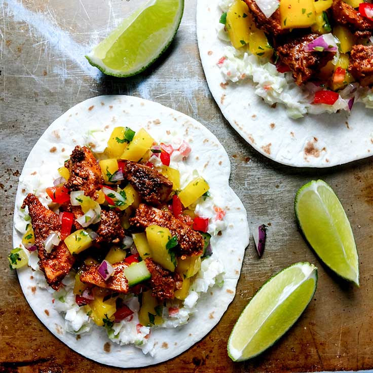 Blackened fish tacos with lime wedge