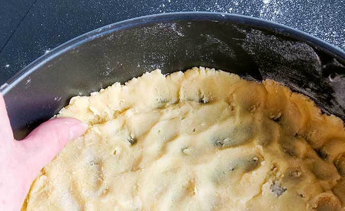 shortbread crust in springform pan for turtle cheesecake