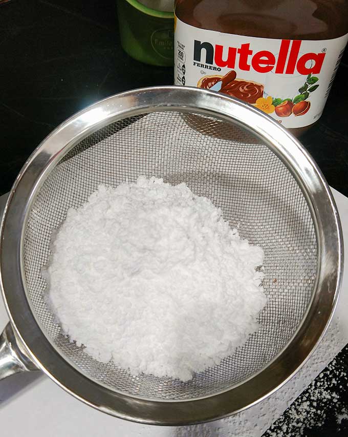 sifting powdered sugar for buttercream frosting