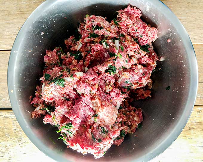 meatloaf with sausage in mixing bowl
