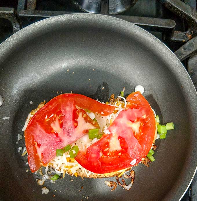 grown-up grilled cheese with bacon and tomato in pan with tomato