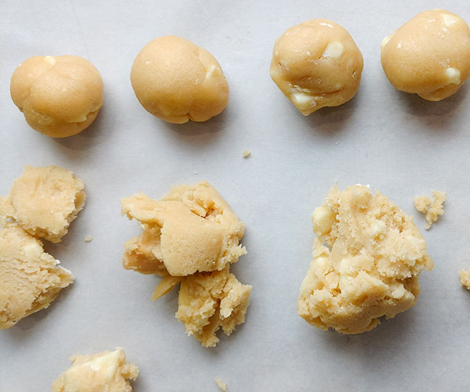 Balls of white chocolate macadamia nut cookie dough