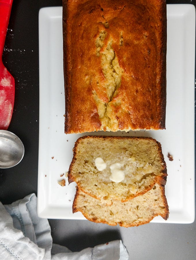 moist banana bread spread with butter