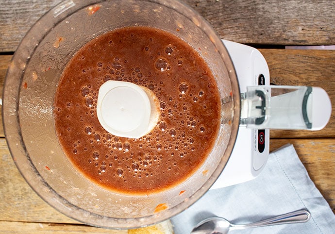 Pureed tomatoes in food processor for Andalusian Gazpacho