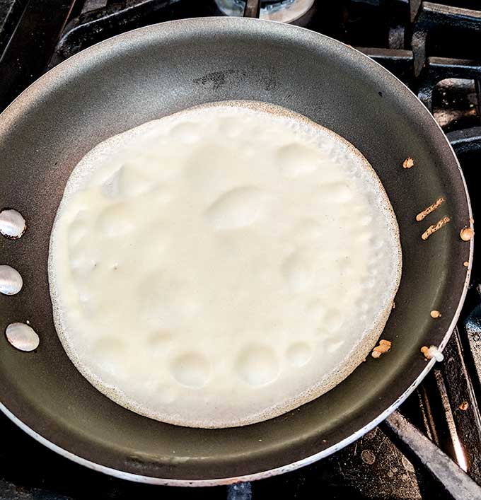 breakfast crepe cooking on first side 