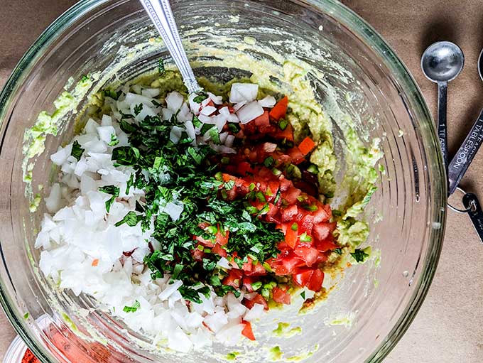 homemade guacamole recipe ingredients mixed in bowl