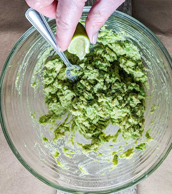 mashing avocado for homemade guacamole recipe