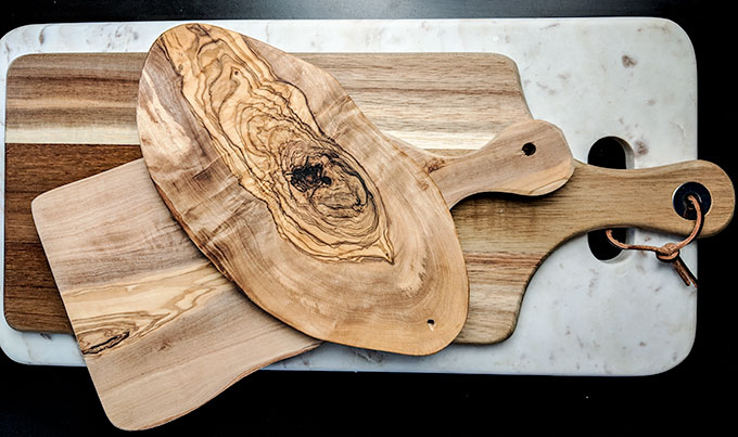 different types of wood and marble boards for charcuterie board