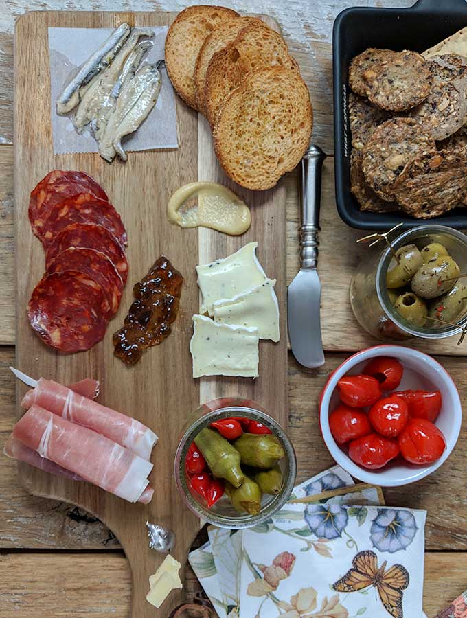 charcuterie board with anchovies and prosciutto