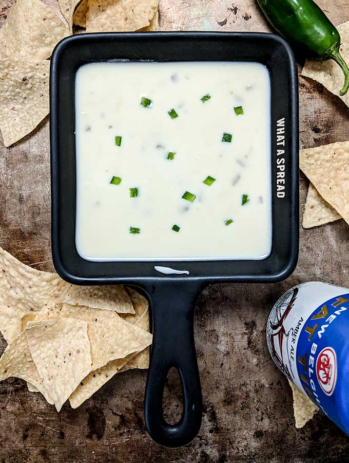 Mexican cheese dip topped with fresh diced jalapenos