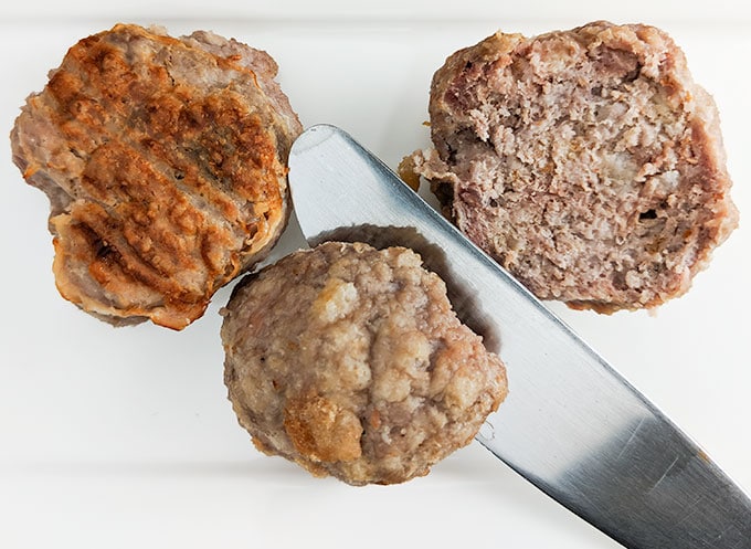 cutting meatball in half for spaghetti sandwich