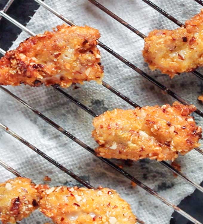 draining oil from cornflake chicken tenders