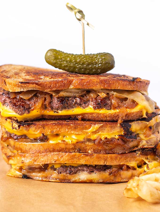 patty melt recipe stacked with a pickle