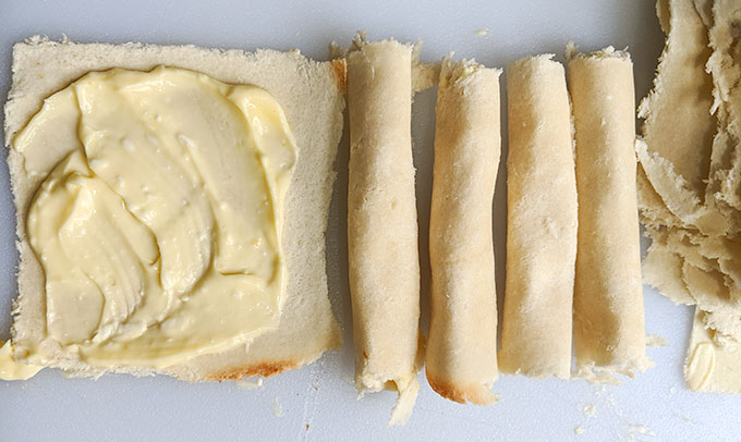 spreading the filling in cinnamon roll bites