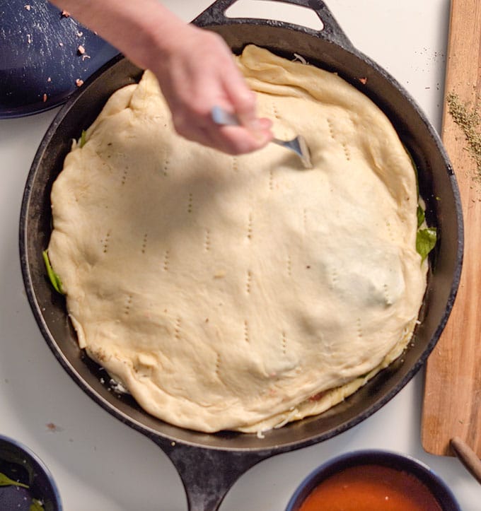 poke holes in pizza dough to release steam
